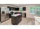 Modern kitchen boasts dark cabinetry, stainless steel appliances, granite countertops, and a functional island at 2037 Langer St, Charlotte, NC 28214