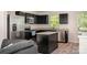 Modern kitchen boasts dark cabinetry, stainless steel appliances, granite countertops, and a functional island at 2037 Langer St, Charlotte, NC 28214