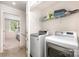 Convenient laundry room with a washer, dryer, and storage shelves for organization at 2037 Langer St, Charlotte, NC 28214