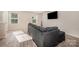 Comfortable living room with vinyl flooring, a gray sofa, and plenty of natural light at 2037 Langer St, Charlotte, NC 28214