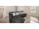 Comfortable living room featuring a grey sofa, modern wood floors, and natural light from a window at 2037 Langer St, Charlotte, NC 28214