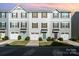 Charming townhomes feature attached garages, colorful entry doors, and well-maintained front lawns at 2037 Langer St, Charlotte, NC 28214
