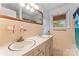 Classic bathroom with double sinks, tile walls, and a large mirror at 2255 Milton Rd, Charlotte, NC 28215