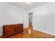 Cozy bedroom with hardwood floors, a vintage dresser, and plenty of natural light at 2255 Milton Rd, Charlotte, NC 28215