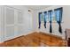 Bright bedroom with hardwood floors, a closet, and stylish blue curtains at 2255 Milton Rd, Charlotte, NC 28215