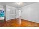 Bedroom with hardwood floors features a ceiling fan and closet at 2255 Milton Rd, Charlotte, NC 28215