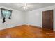Bright bedroom featuring hardwood floors, ceiling fan, and one window at 2255 Milton Rd, Charlotte, NC 28215