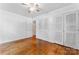 Bedroom featuring hardwood floors, ceiling fan, and ample closet space at 2255 Milton Rd, Charlotte, NC 28215