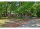 Charming house with mature trees, landscaping, and a driveway, showcasing curb appeal at 2255 Milton Rd, Charlotte, NC 28215