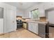Kitchen with stainless steel appliances, neutral cabinets, tile floor, and plenty of counter space at 2255 Milton Rd, Charlotte, NC 28215