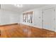 Inviting living room with hardwood floors, a large window, and neutral paint creating a cozy atmosphere at 2255 Milton Rd, Charlotte, NC 28215