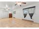 Inviting living area with tile floors, two ceiling fans, and several windows for natural light at 2255 Milton Rd, Charlotte, NC 28215