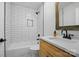 A modern bathroom with white subway tile, tub, and wood vanity at 253 Hall Nw Ave, Concord, NC 28027