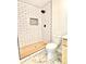 Bathroom with a toilet adjacent to a shower featuring classic white subway tile at 253 Hall Nw Ave, Concord, NC 28027
