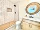Bathroom featuring subway tile shower, stylish vanity, and round decorative mirror at 253 Hall Nw Ave, Concord, NC 28027
