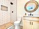 This bathroom features a walk-in shower with elegant white subway tile and a round decorative mirror at 253 Hall Nw Ave, Concord, NC 28027