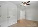 View of bedroom features light hardwood floors and a ceiling fan at 253 Hall Nw Ave, Concord, NC 28027
