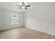 A bedroom with light hardwood floors and a ceiling fan at 253 Hall Nw Ave, Concord, NC 28027