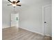 An additional bedroom view with light hardwood floors and a ceiling fan at 253 Hall Nw Ave, Concord, NC 28027