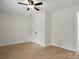 Bright bedroom features a ceiling fan, wood-look floors, and a double door closet at 253 Hall Nw Ave, Concord, NC 28027
