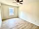 This bedroom features wood-look floors and a ceiling fan at 253 Hall Nw Ave, Concord, NC 28027