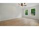 Bedroom with wood-look flooring, ceiling fan and natural light at 253 Hall Nw Ave, Concord, NC 28027