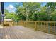 View of the deck overlooking a wooded area, complete with wooden railings for privacy and safety at 253 Hall Nw Ave, Concord, NC 28027