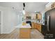 Kitchen with stainless appliances, island, and bright wood cabinets at 253 Hall Nw Ave, Concord, NC 28027