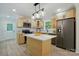 New kitchen with stainless appliances, island, and bright wood cabinets at 253 Hall Nw Ave, Concord, NC 28027