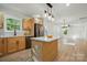 Open concept kitchen with stainless appliances and view to living room at 253 Hall Nw Ave, Concord, NC 28027