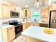 Modern kitchen featuring stainless steel appliances, quartz countertops, and a center island at 253 Hall Nw Ave, Concord, NC 28027