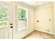 Bright laundry room featuring new flooring and exterior door to a deck at 253 Hall Nw Ave, Concord, NC 28027