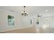 Bright living room features modern chandelier, fan, wood-look flooring and fresh paint at 253 Hall Nw Ave, Concord, NC 28027