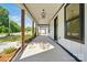 Cozy covered porch with wooden columns and pendant lighting at 253 Hall Nw Ave, Concord, NC 28027