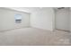 Neutral carpeted bedroom with one large window providing natural light at 2588 Blue Sky Meadows Dr, Monroe, NC 28110
