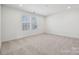 Spacious bedroom with neutral carpet, recessed lighting, and two windows at 2588 Blue Sky Meadows Dr, Monroe, NC 28110