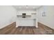 Bright kitchen with white cabinets, an island with countertop seating, and modern stainless steel appliances at 2588 Blue Sky Meadows Dr, Monroe, NC 28110