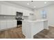 Bright kitchen with white cabinets, modern stainless steel appliances, an island with countertop, and recessed lighting at 2588 Blue Sky Meadows Dr, Monroe, NC 28110