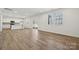 Open concept living room and kitchen featuring light-colored floors, recessed lighting, and natural light at 2588 Blue Sky Meadows Dr, Monroe, NC 28110