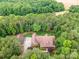 An aerial view shows this brick home nestled amongst mature trees on a sprawling lot at 270 North St, Salisbury, NC 28147