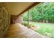Inviting back porch with a wooden deck, views of the lawn, and surrounded by lush landscaping at 270 North St, Salisbury, NC 28147