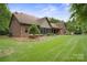 Brick home's backyard with well-maintained lawn and lush landscaping, perfect for outdoor activities at 270 North St, Salisbury, NC 28147