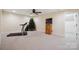 Spacious carpeted basement area featuring a ceiling fan, television, and fitness equipment at 270 North St, Salisbury, NC 28147