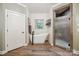 Elegant bathroom with a soaking tub, a separate glass-enclosed shower, and shiplap walls at 270 North St, Salisbury, NC 28147