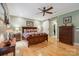 Comfortable bedroom with a wooden bed frame, ceiling fan, and sliding barn door leading to the closet at 270 North St, Salisbury, NC 28147