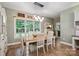 Bright dining room features a large window with backyard views, stylish furnishings, and hardwood floors at 270 North St, Salisbury, NC 28147