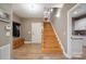Entryway features a wood staircase, coat rack, storage bench, and access to a half bathroom at 270 North St, Salisbury, NC 28147