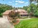 Stately brick home with a three-car garage, manicured lawn, and inviting wrap-around porch at 270 North St, Salisbury, NC 28147