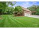 Exterior home view with a manicured lawn and a four-car garage perfect for car enthusiasts at 270 North St, Salisbury, NC 28147