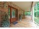 Inviting covered front porch with wood floors, brick facade, rocking chairs, and decorative glass front door at 270 North St, Salisbury, NC 28147
